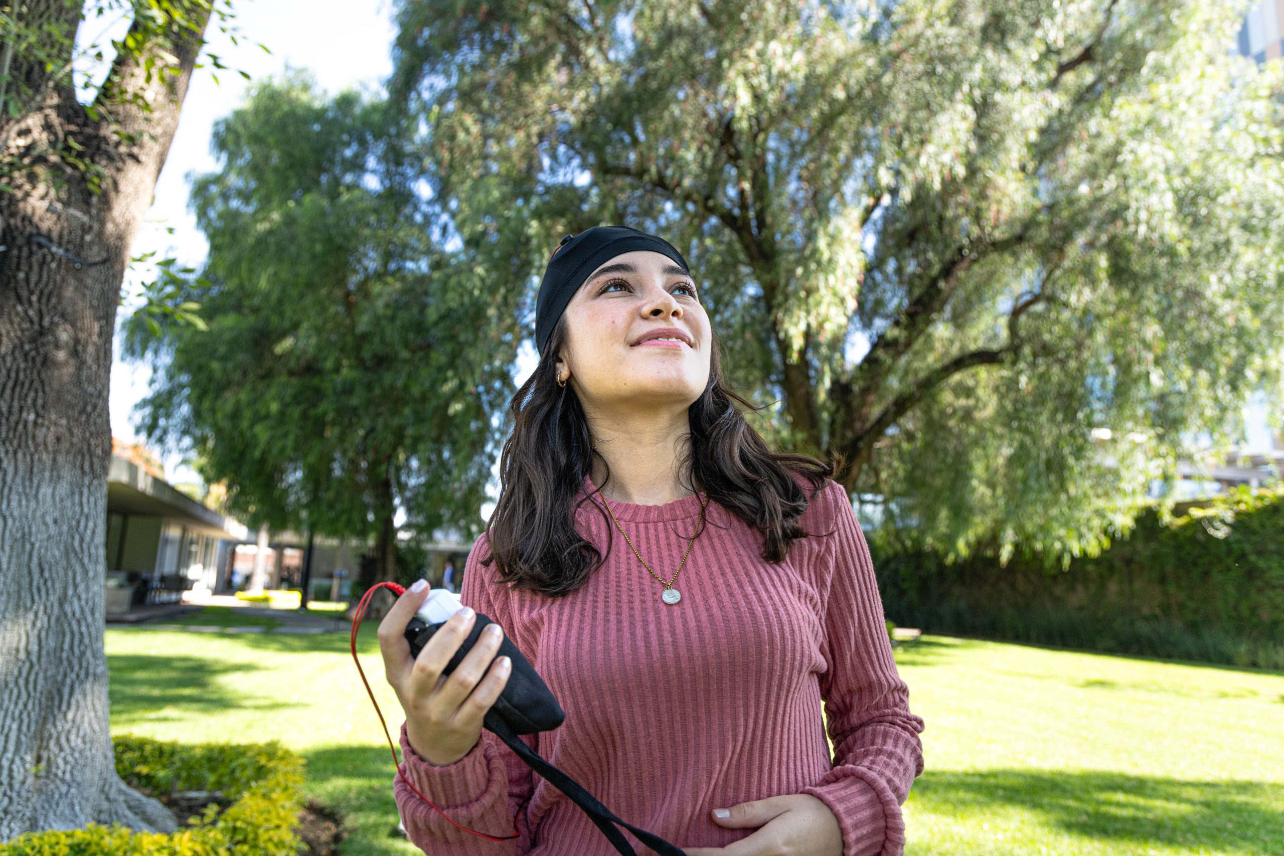 a woman holding a device in her hand